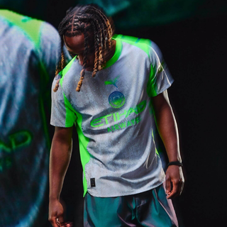 Manchester City 2025/26 third jersey in gray with neon green details, player model showing the rain-inspired design.